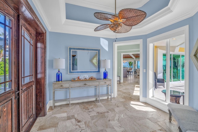 interior space featuring ornamental molding, a raised ceiling, and plenty of natural light