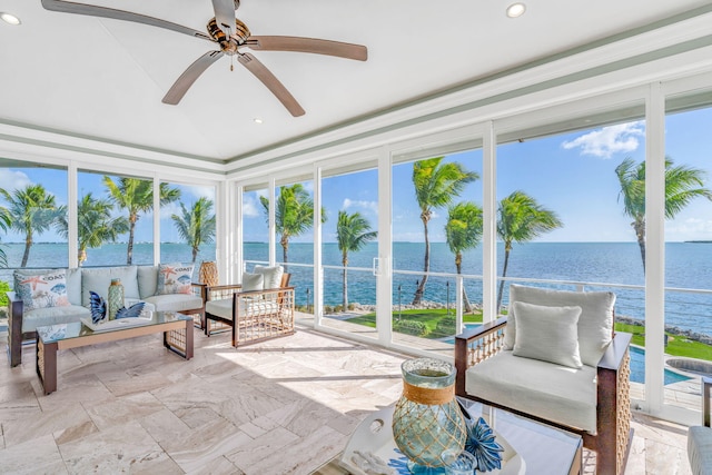 sunroom with a water view, ceiling fan, and lofted ceiling