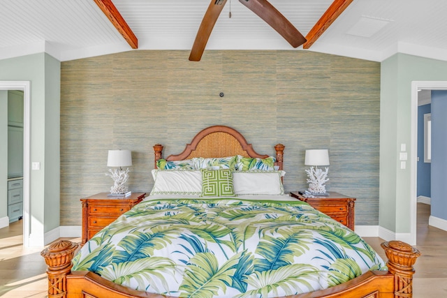 bedroom featuring lofted ceiling with beams and light wood-type flooring