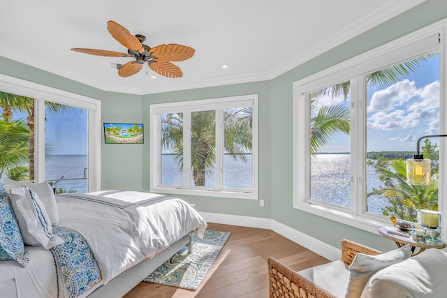 bedroom featuring crown molding, ceiling fan, and hardwood / wood-style flooring