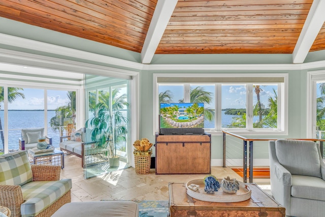 sunroom featuring lofted ceiling with beams, wooden ceiling, and a water view