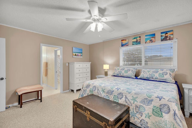 carpeted bedroom with crown molding, ensuite bathroom, ceiling fan, and a textured ceiling