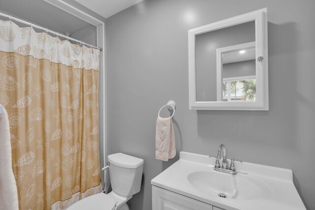 bathroom with vanity, toilet, and a shower with shower curtain