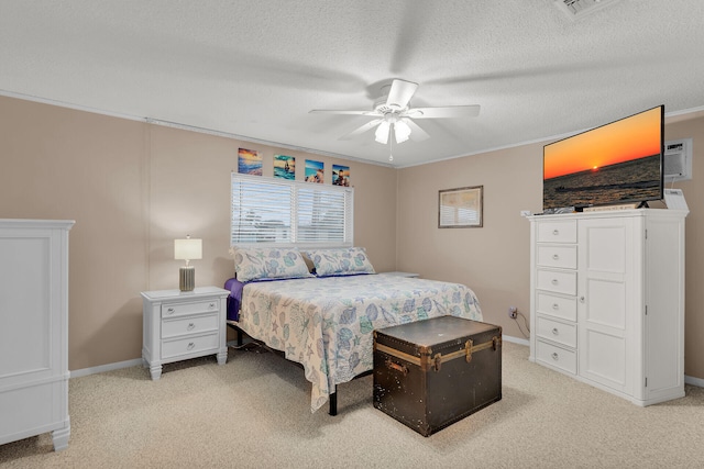 carpeted bedroom with crown molding, ceiling fan, and a textured ceiling