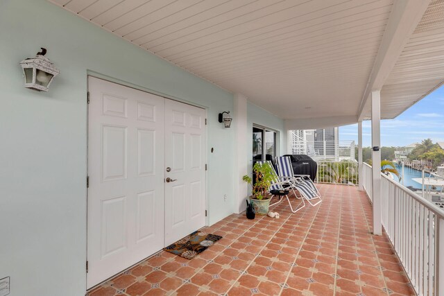 view of patio / terrace with a water view and area for grilling