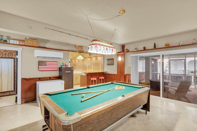 playroom with light tile patterned floors, pool table, a wall unit AC, and wood walls