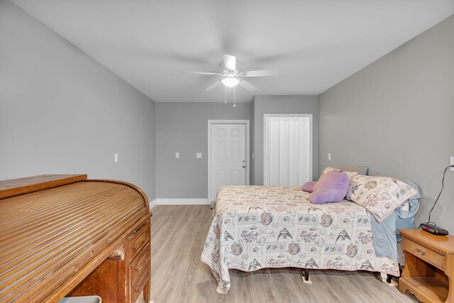 bedroom with a closet, ceiling fan, and light wood-type flooring