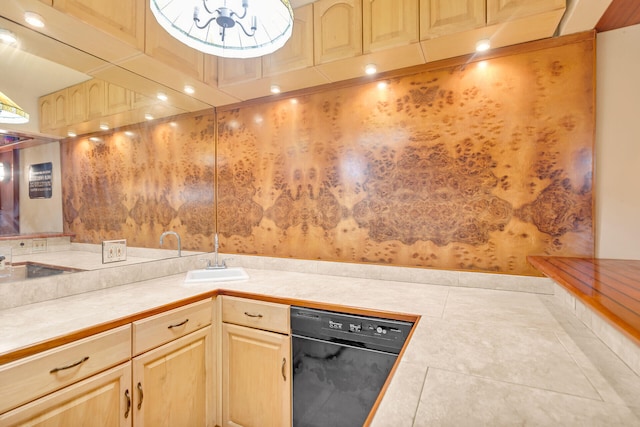 kitchen with sink, tile patterned flooring, black dishwasher, light brown cabinetry, and tile countertops