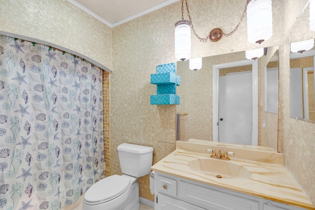 bathroom with vanity, crown molding, and toilet