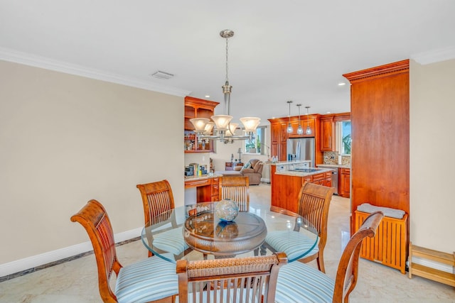 dining room with an inviting chandelier and crown molding