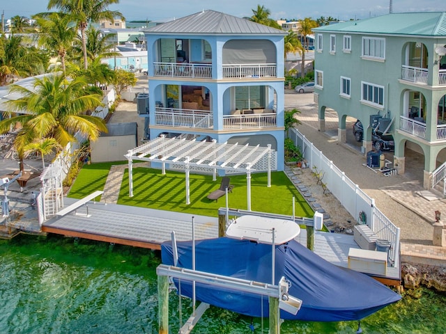 back of house featuring a water view, a balcony, and a pergola