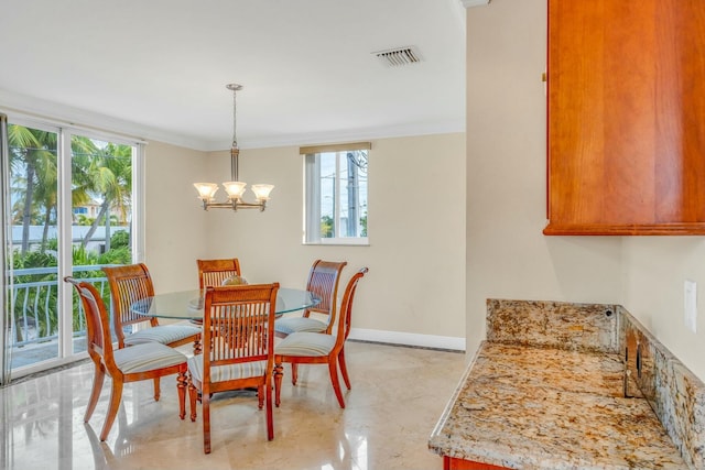 dining space with an inviting chandelier and ornamental molding