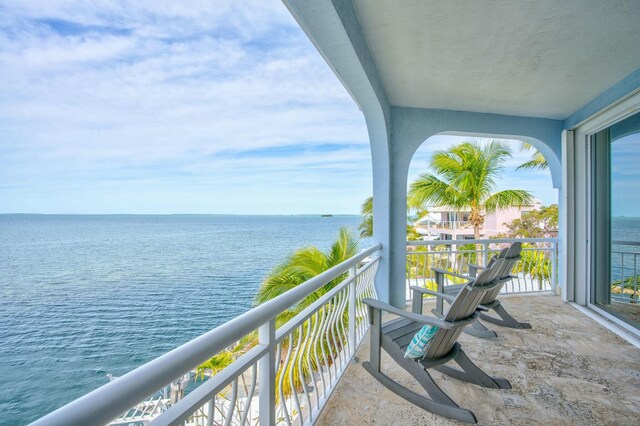 balcony featuring a water view