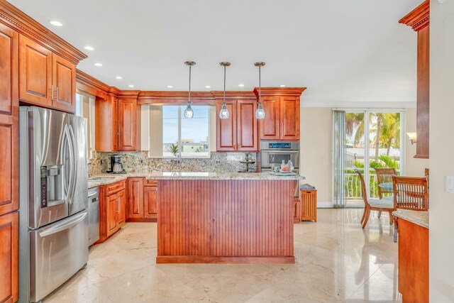 kitchen featuring appliances with stainless steel finishes, tasteful backsplash, hanging light fixtures, a center island, and light stone countertops