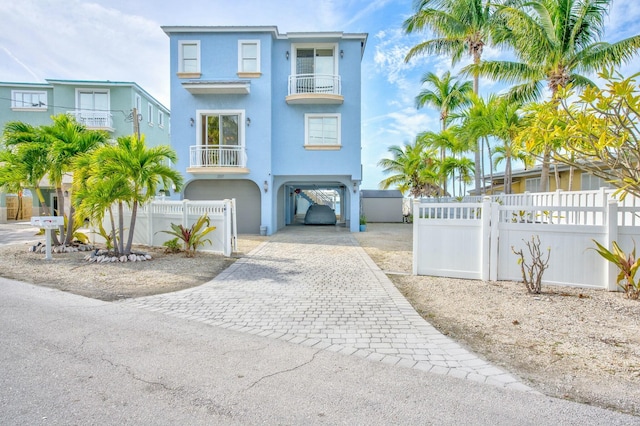 coastal home featuring a carport and a balcony