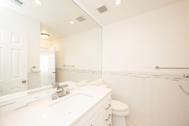 3314 Northside Dr Unit 145, Key West, FL 33040 - bathroom with vanity, tile walls, recessed lighting, and a wainscoted wall