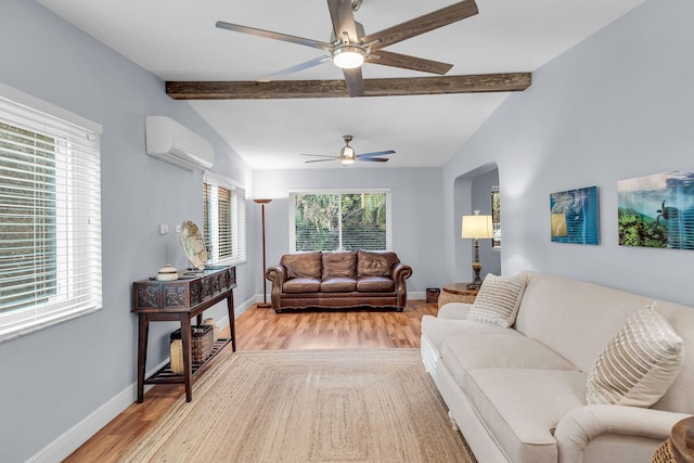 living room featuring ceiling fan, light hardwood / wood-style floors, a wall unit AC, and vaulted ceiling with beams