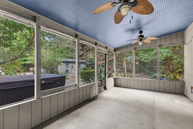 unfurnished sunroom with ceiling fan and a healthy amount of sunlight