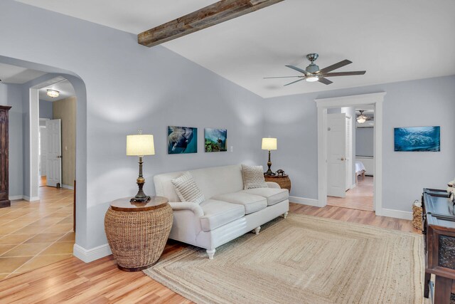 living room featuring ceiling fan, beam ceiling, and light hardwood / wood-style floors