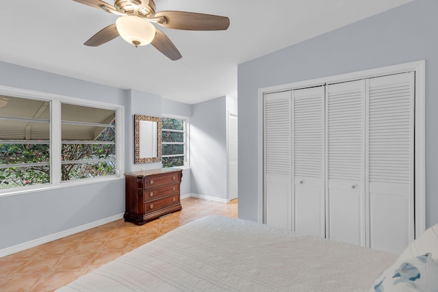 tiled bedroom featuring ceiling fan and a closet