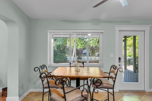 dining space featuring ceiling fan and light tile patterned floors