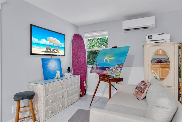 sitting room featuring a wall mounted AC and light tile patterned flooring