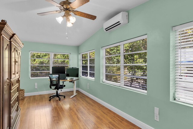 home office with ceiling fan, lofted ceiling, light wood-type flooring, and a wall unit AC