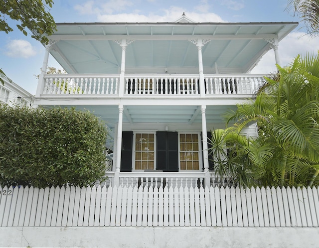 view of front facade featuring a balcony and covered porch