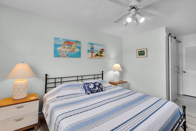 389 N Anglers Dr Unit 105, Marathon, FL 33050 - bedroom featuring a barn door, wood finished floors, and ceiling fan