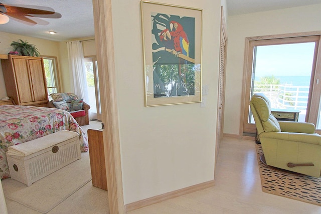 bedroom with multiple windows and light hardwood / wood-style floors