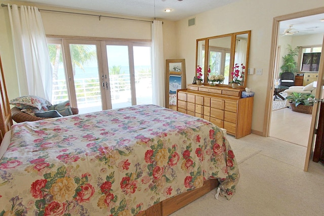 bedroom with light carpet, access to exterior, and french doors