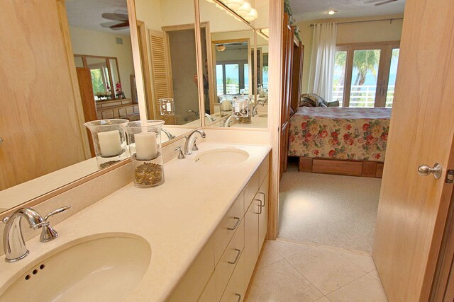 bathroom with tile patterned flooring, vanity, a wealth of natural light, and ceiling fan