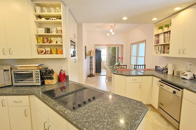 kitchen featuring white appliances, dark stone counters, kitchen peninsula, and white cabinets