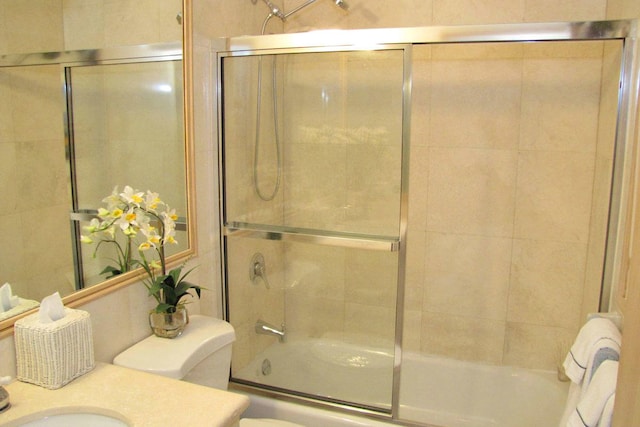 full bathroom with vanity, combined bath / shower with glass door, and toilet