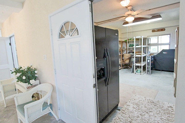 kitchen with black fridge and ceiling fan