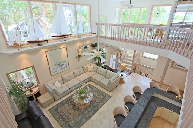 living room featuring a high ceiling and ceiling fan