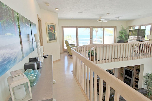 hallway featuring plenty of natural light and a textured ceiling