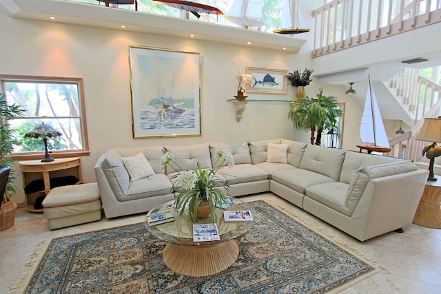 living room with a towering ceiling