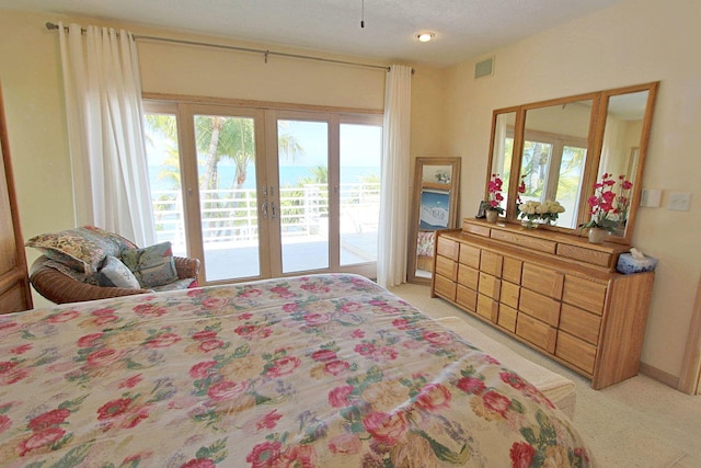 carpeted bedroom featuring french doors and access to outside