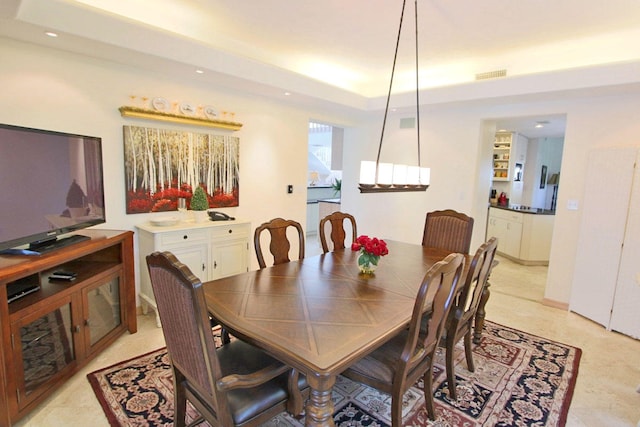 dining space featuring a tray ceiling