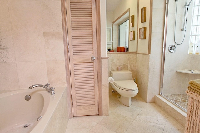 bathroom featuring toilet, shower with separate bathtub, tile patterned flooring, and tile walls