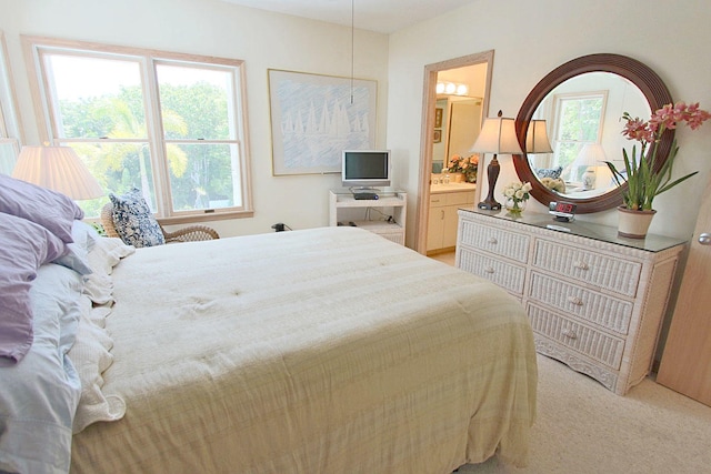 bedroom featuring light colored carpet and connected bathroom