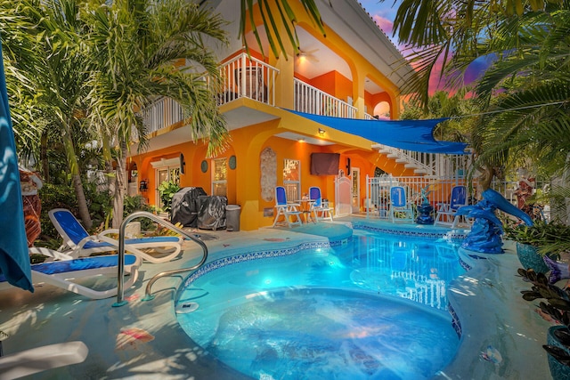 view of pool with a patio area, a fenced in pool, and a jacuzzi