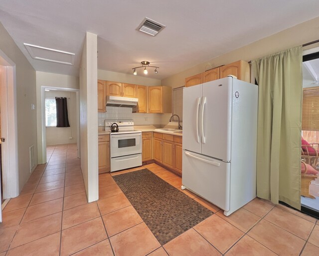 kitchen featuring light tile patterned flooring, sink, decorative backsplash, light brown cabinets, and white appliances