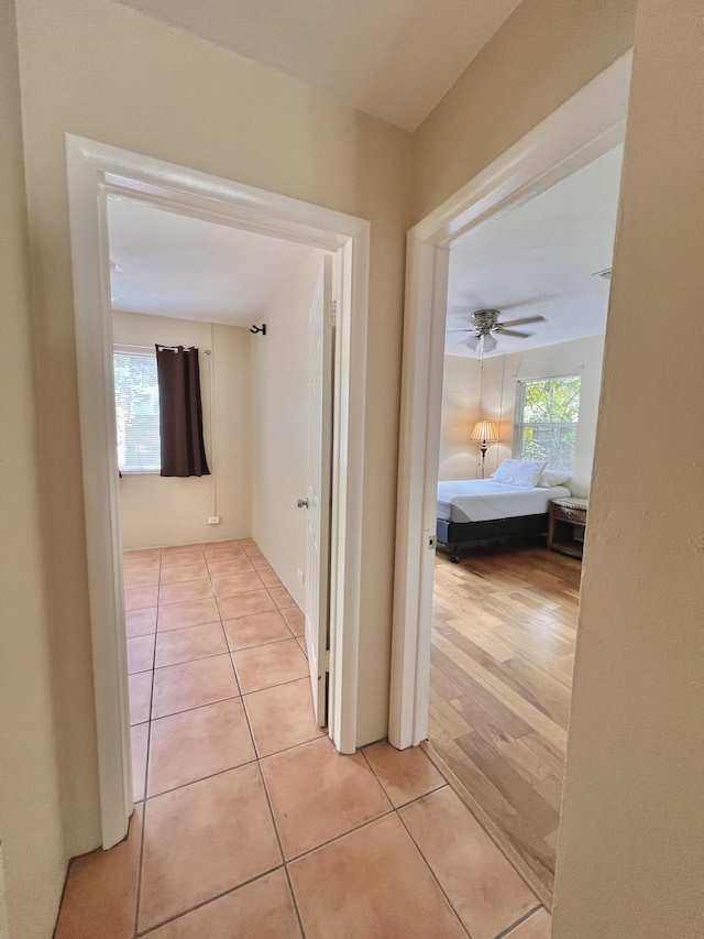 corridor featuring light tile patterned floors