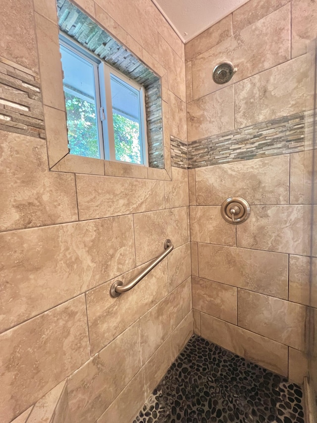 bathroom with a tile shower