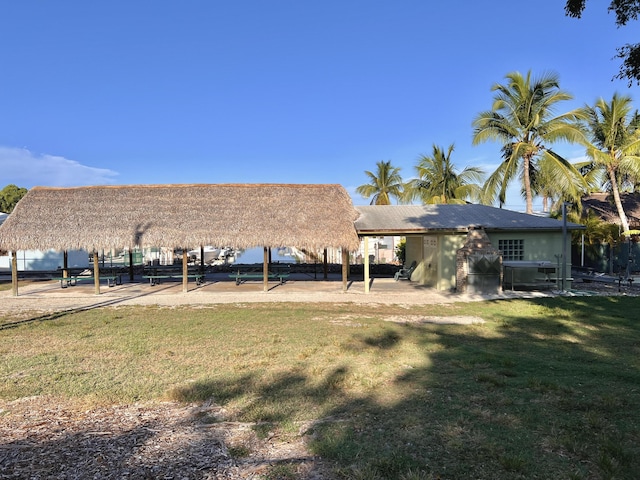 rear view of house with a lawn and a water view