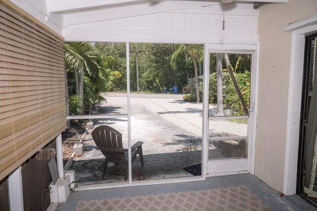 exterior space featuring lofted ceiling and concrete flooring