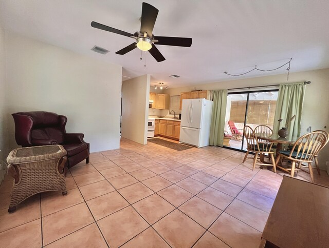 interior space with ceiling fan, sink, and light tile patterned floors