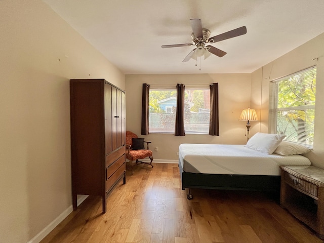 bedroom with ceiling fan and light hardwood / wood-style floors